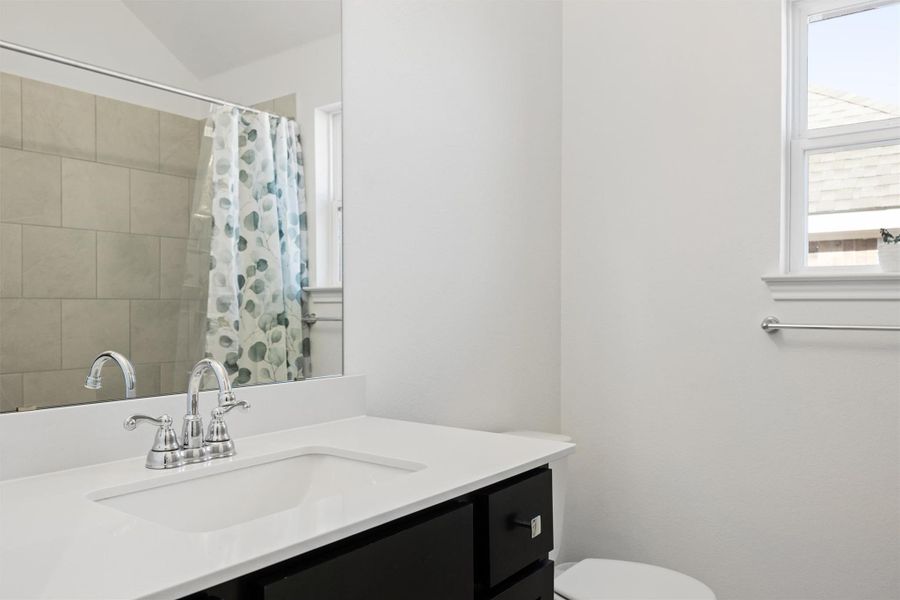 Bathroom with vanity and a shower with shower curtain Bathroom with vanity and a shower with shower curtain