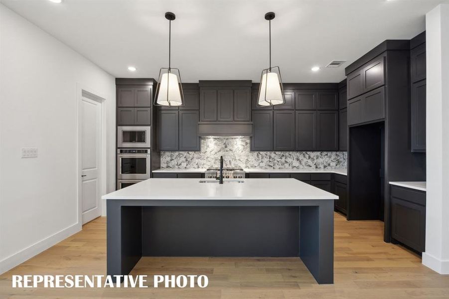 Your new chefs kitchen features an oversized island that offers the ideal space for friends and family to gather round!  REPRESENTATIVE PHOTO