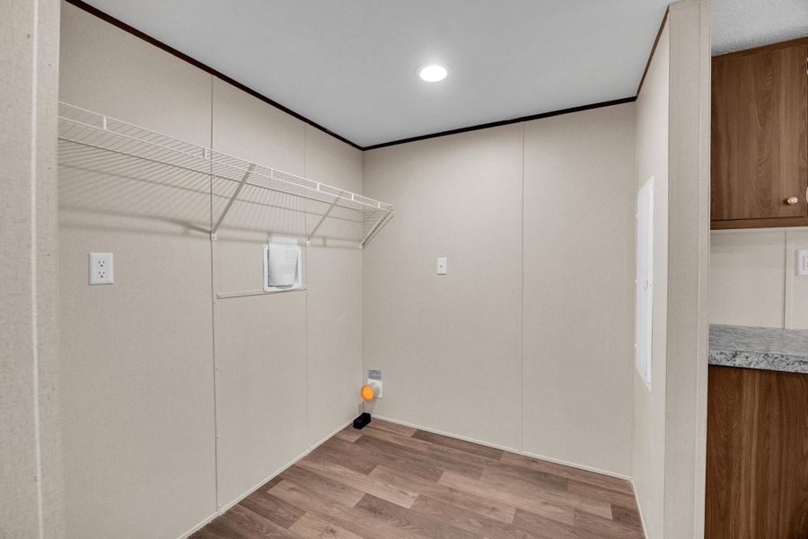 Washroom featuring light wood-type flooring, crown molding, and recessed lighting
