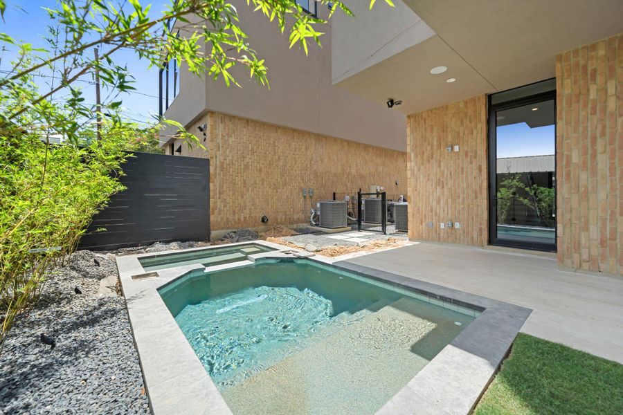 An inviting backyard oasis offers a sparkling plunge pool and an adjacent hot tub. An inviting backyard oasis offers a sparkling plunge pool and an adjacent hot tub.