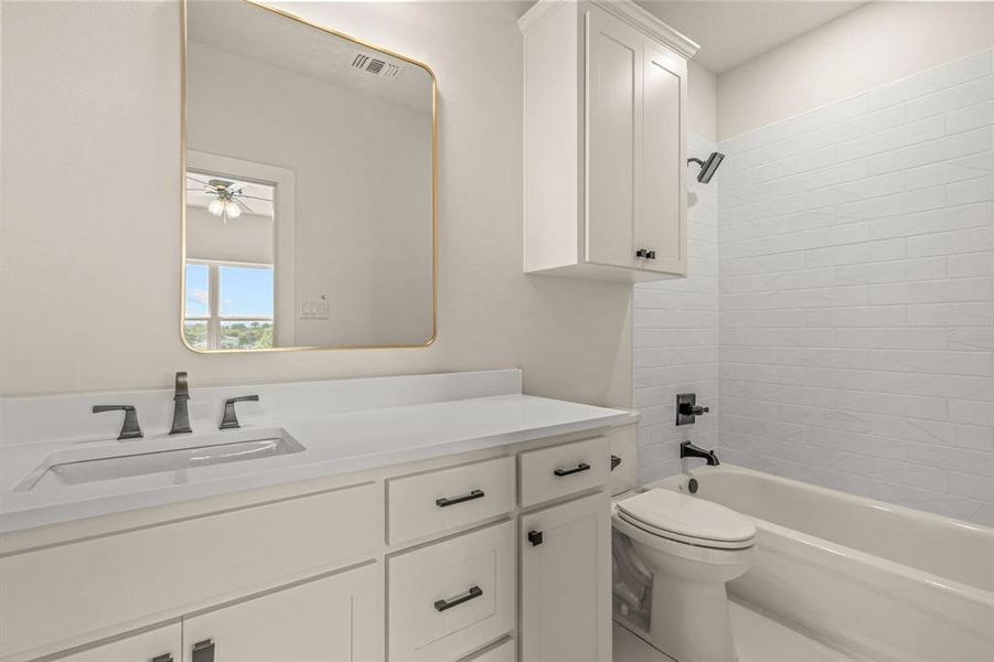 Full bath with toilet, shower / bathtub combination, vanity, and a ceiling fan