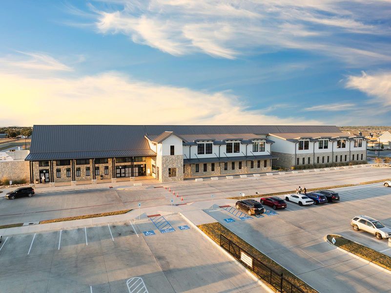 View of building exterior featuring uncovered parking