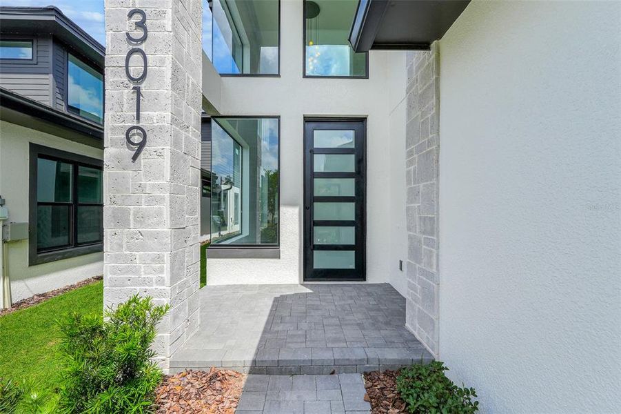 Exterior details and patio area of a home in Hampton Green at Providence, Davenport (Image 3).