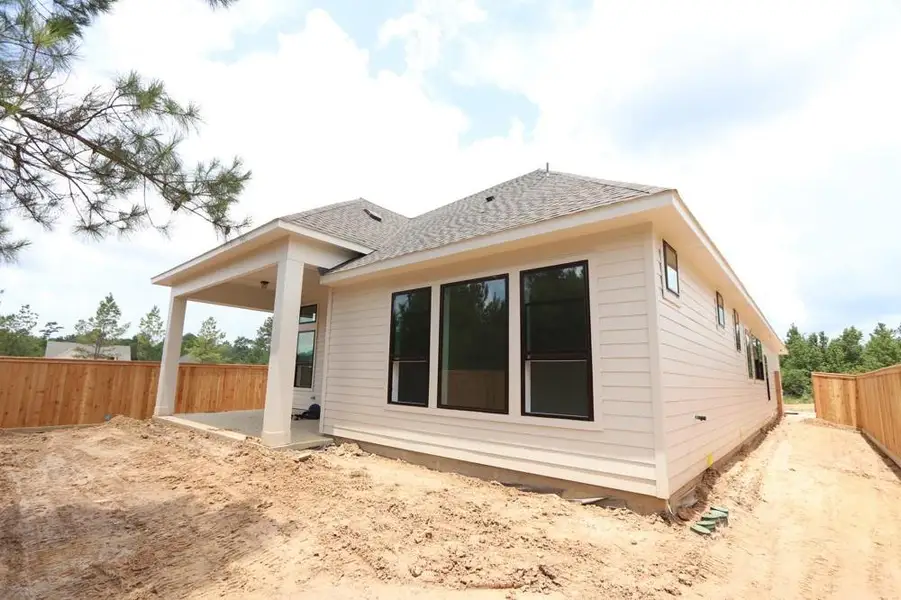 Front exterior of a new home in Kresston, Magnolia, TX, highlighting curb appeal (Image 1).