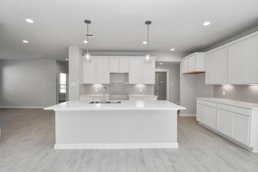 This kitchen is by far any chef’s dream! This spacious kitchen features high ceilings, stained wood cabinets, granite countertop, SS appliances, modern tile backsplash, recessed lighting, extended counter space, granite kitchen island with double sink, and space for breakfast bar, and a walk-in pantry all overlooking your huge family room. This kitchen is by far any chef’s dream! This spacious kitchen features high ceilings, stained wood cabinets, granite countertop, SS appliances, modern tile backsplash, recessed lighting, extended counter space, granite kitchen island with double sink, and space for breakfast bar, and a walk-in pantry all overlooking your huge family room.