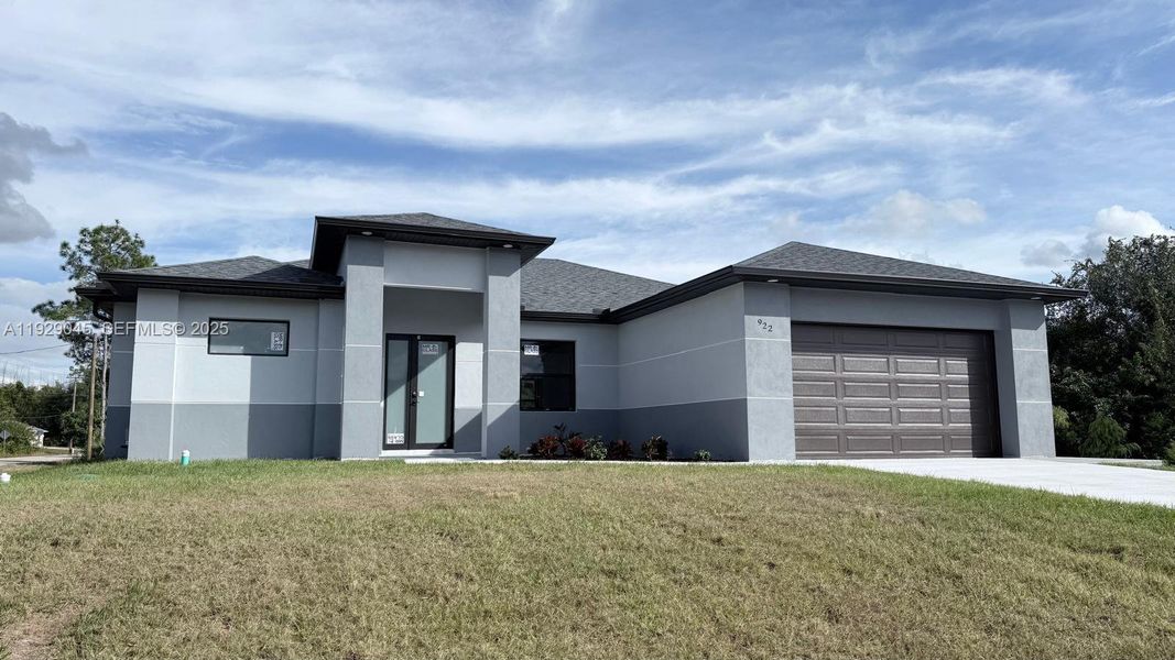 Front exterior of a new home in , Lehigh Acres, FL, highlighting curb appeal (Image 2). Front exterior of a new home in , Lehigh Acres, FL, highlighting curb appeal (Image 2).