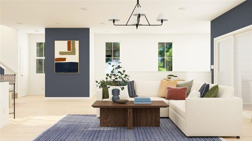 Sitting room featuring light wood-style floors and a chandelier