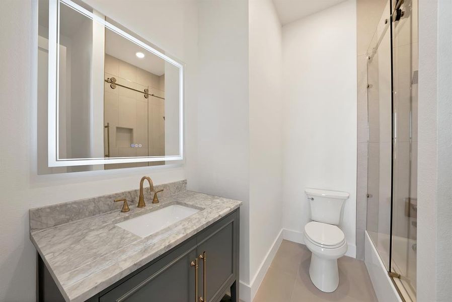 Full bathroom with vanity and bath / shower combo with glass door