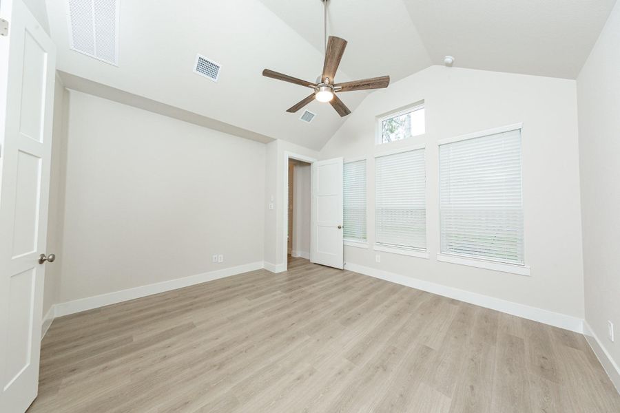 This spacious primary bedroom features an eye-catching architectural niche that offers a dedicated, recessed area perfect for showcasing art, a reading nook, or extra decor, adding custom character without taking up valuable floor space.