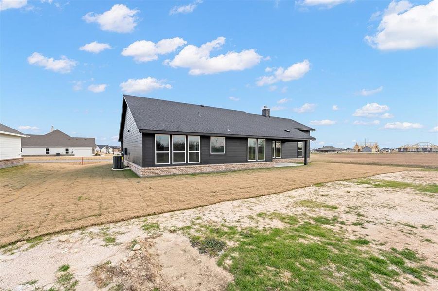 Back of house with a patio area, a chimney, and a yard