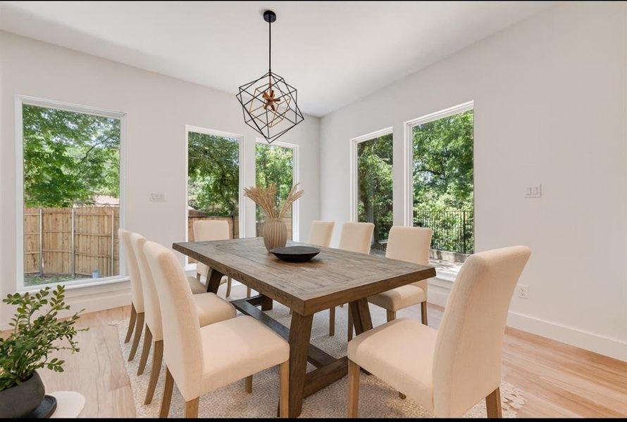 Dining space featuring light wood-type flooring and healthy amount of natural light