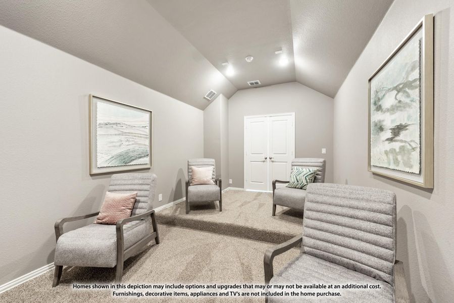 Sitting room with vaulted ceiling, gray accent chairs, carpet flooring, and framed wall art Sitting room with vaulted ceiling, gray accent chairs, carpet flooring, and framed wall art