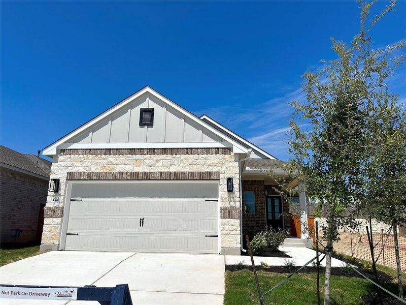 Front exterior of a new home in Crosswinds, Kyle, TX, highlighting curb appeal (Image 21).