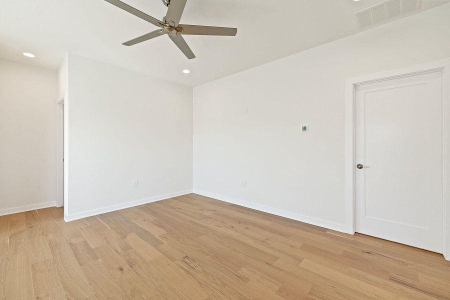 Unfurnished room featuring light wood flooring, baseboards, visible vents, and recessed lighting