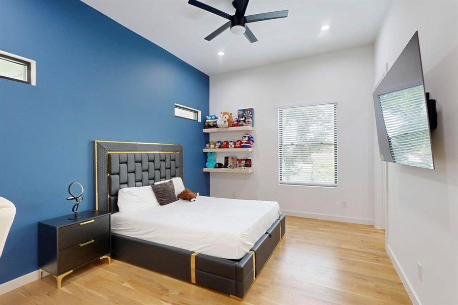 Bedroom with light wood finished floors, recessed lighting, and a ceiling fan Bedroom with light wood finished floors, recessed lighting, and a ceiling fan