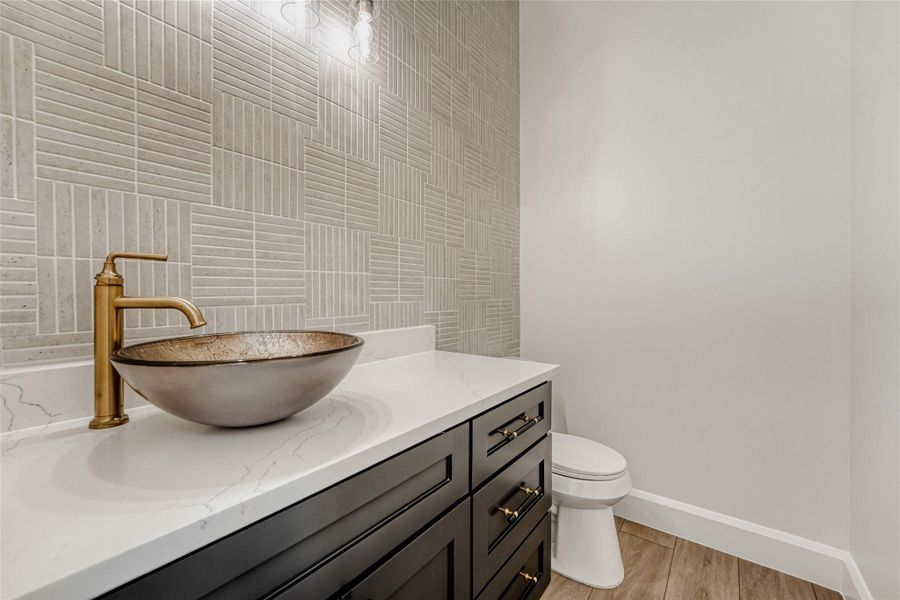 There's also a stylish main floor guest powder room with a chic vanity and designer backsplash.