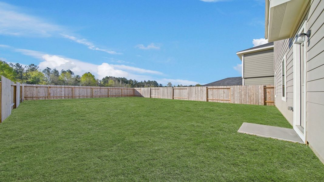 Exterior details and patio area of a home in The Canopies, Splendora (Image 16).