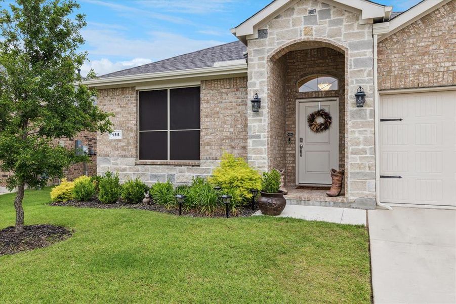 Front exterior of a new home in Bluestem, Rhome, TX, highlighting curb appeal (Image 21). Front exterior of a new home in Bluestem, Rhome, TX, highlighting curb appeal (Image 21).