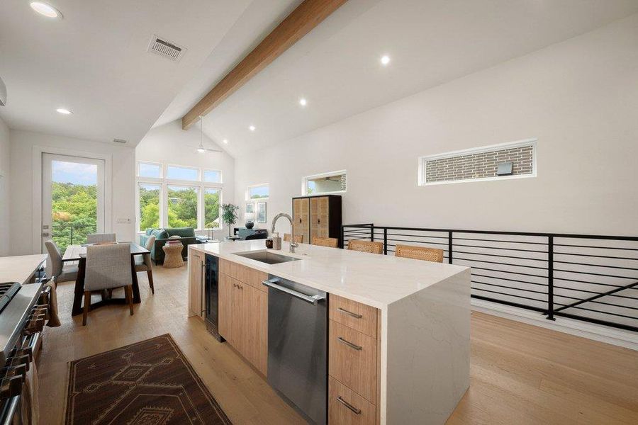 A luminous open-concept living space integrates a modern kitchen and dining area, all under soaring ceilings. A luminous open-concept living space integrates a modern kitchen and dining area, all under soaring ceilings.