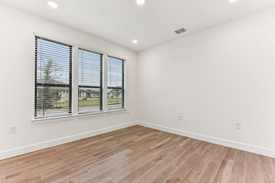 Unfurnished room with light wood-type flooring and recessed lighting Unfurnished room with light wood-type flooring and recessed lighting