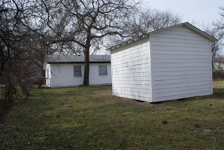 Large backyard and another view of the large shed that provides extra storage.