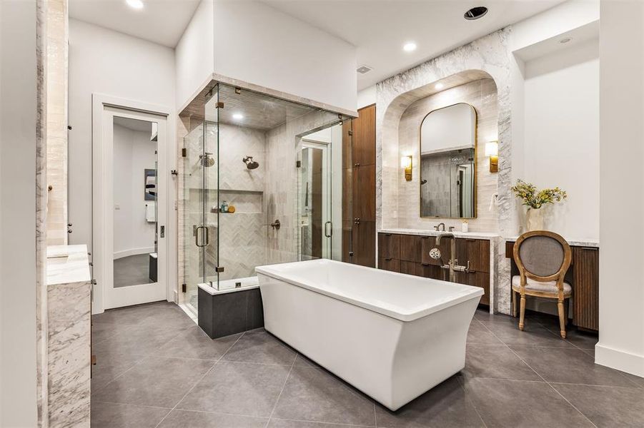 The spa inspired ensuite features separate vanities, giving the bathroom a balanced, functional layout with plenty of personal space