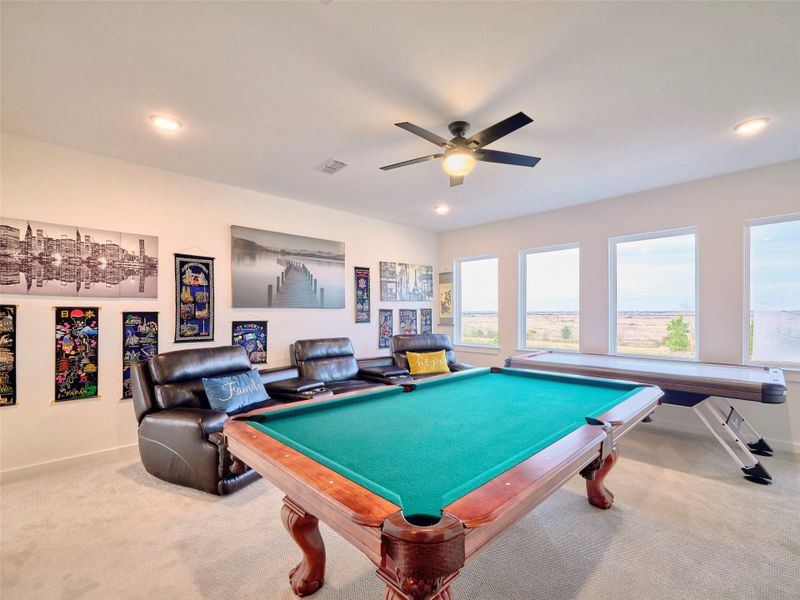 Enjoy movie nights in your private game room and theater, conveniently located by the kitchen stairs.
