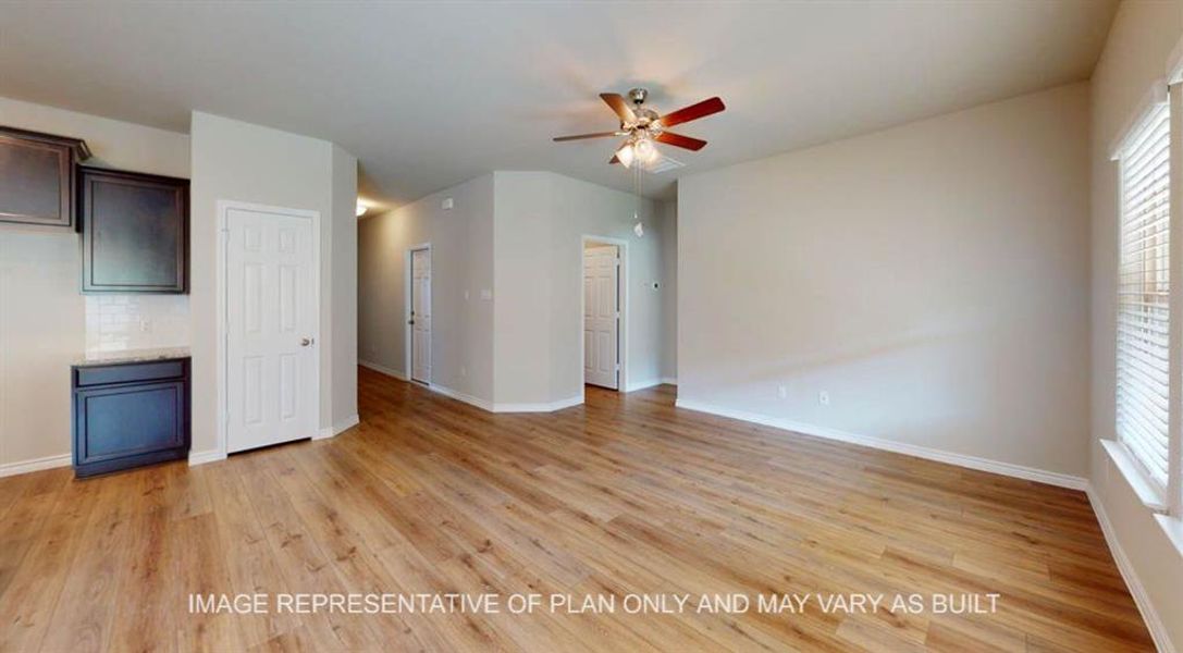 Unfurnished living room featuring ceiling fan, light wood-type flooring, and plenty of natural light Unfurnished living room featuring ceiling fan, light wood-type flooring, and plenty of natural light
