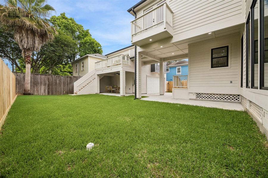 The backyard creates a rare sense of openness for the area, pairing usable lawn space with covered entertaining areas and elevated terraces designed for indoor-outdoor living. The layout also offers the potential for a future pool addition within the backyard space.