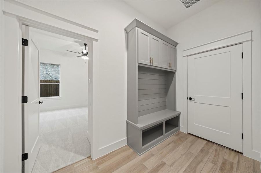 Mudroom with baseboards and light wood finished floors
