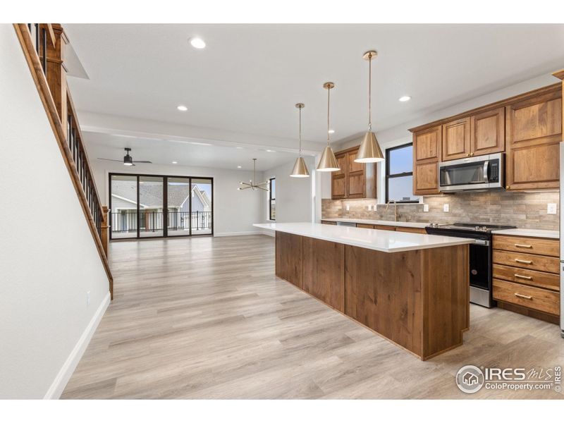 The kitchen features a large island and lots of counter space and cabinets