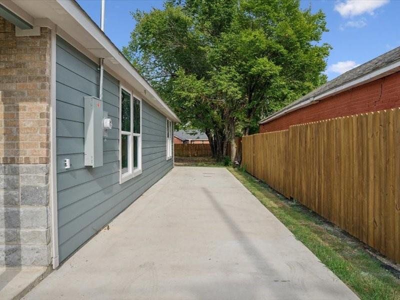 View of side of home featuring a patio area