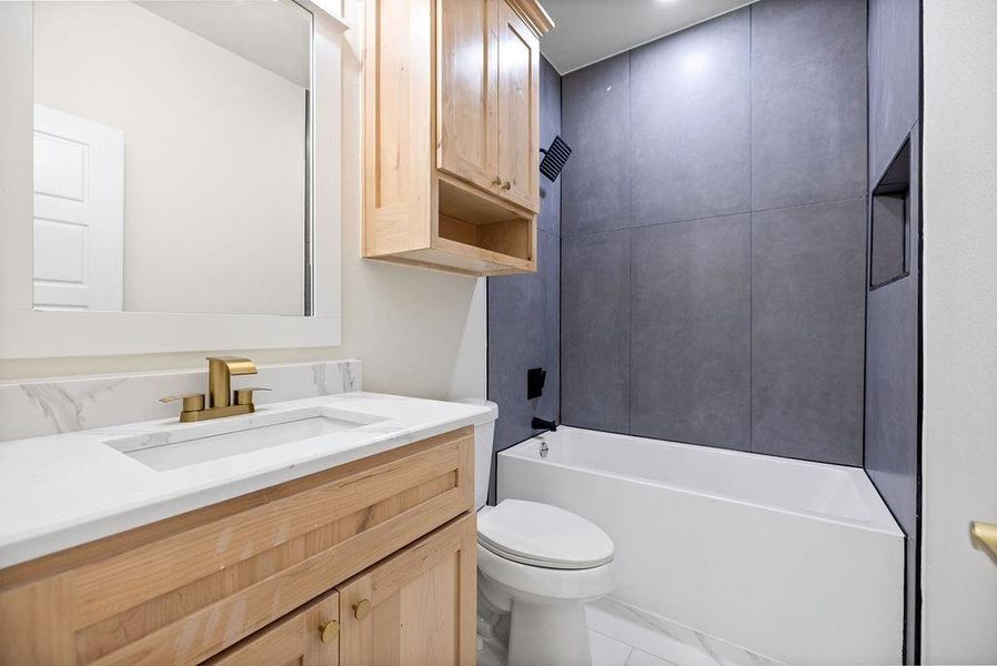 Full bath featuring toilet,  shower combination, and vanity