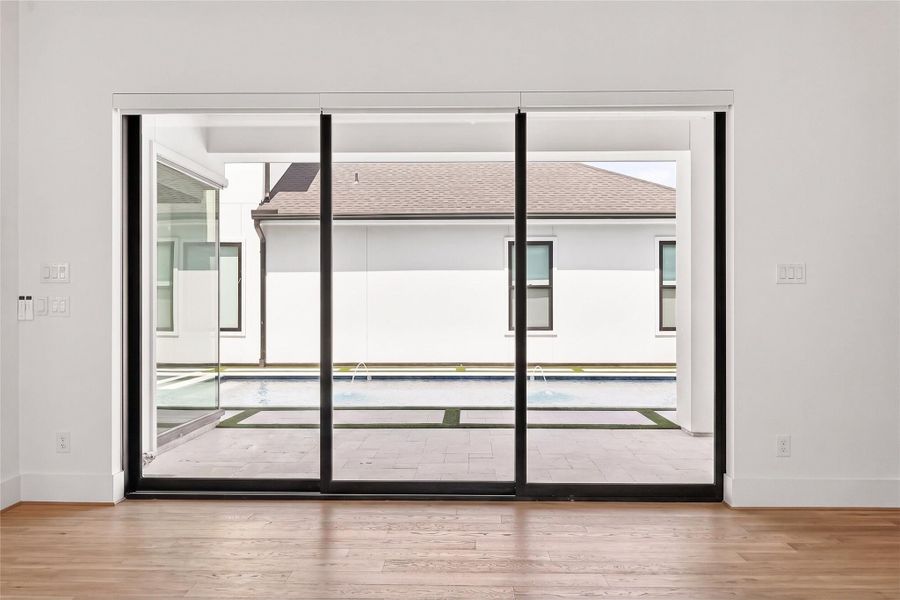 Family room view of sliding glass doors that open directly to the patio and pool!