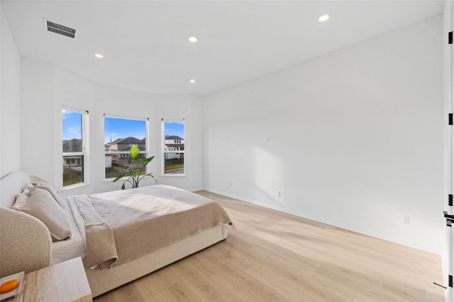 Bedroom with light wood-style floors and recessed lighting