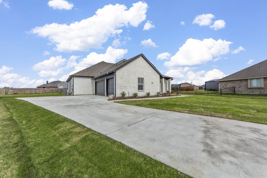 Representative exterior photo of a completed home built from the Logan II by Robbie Hale Homes in High Meadows Estates, Nevada, TX (Image 25). Representative exterior photo of a completed home built from the Logan II by Robbie Hale Homes in High Meadows Estates, Nevada, TX (Image 25).