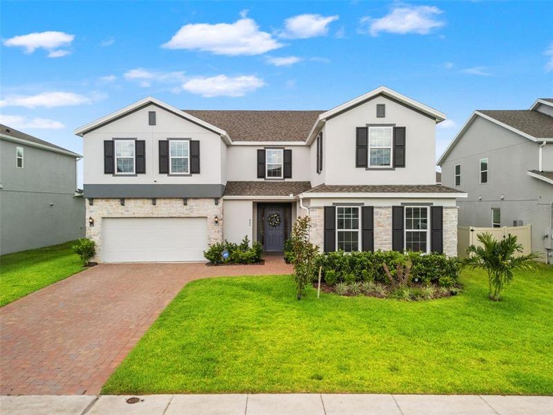 Front exterior of a new home in , Minneola, FL, highlighting curb appeal (Image 29). Front exterior of a new home in , Minneola, FL, highlighting curb appeal (Image 29).