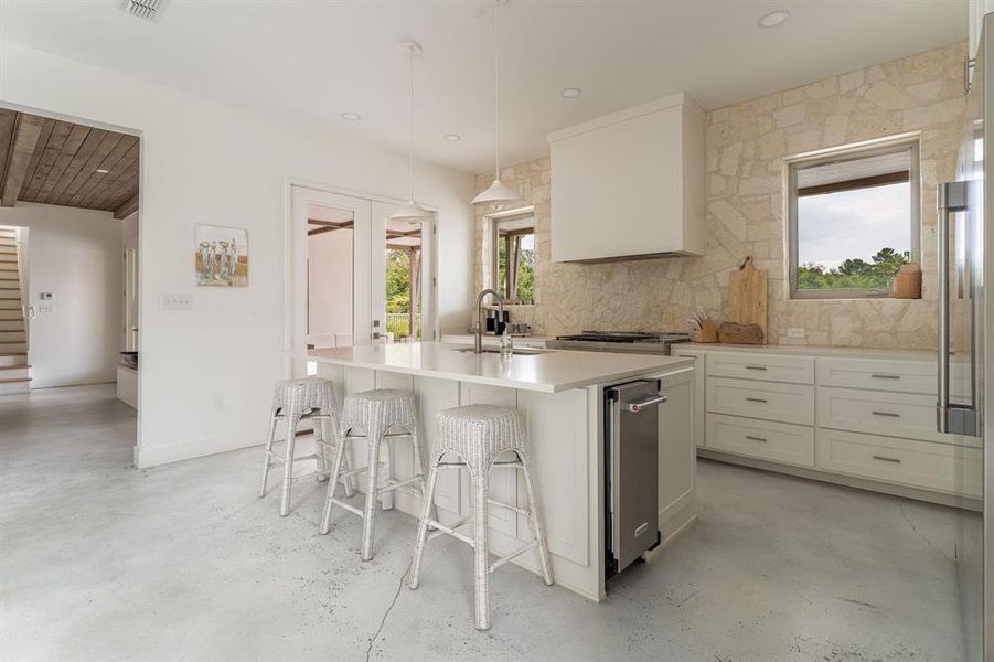 Back of house at dusk with a patio area, a balcony, a chimney, and a water view Back of house at dusk with a patio area, a balcony, a chimney, and a water view
