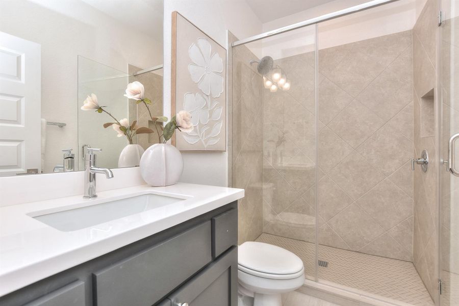 Bathroom with vanity and a stall shower