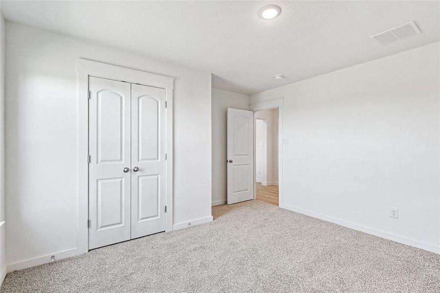 Unfurnished bedroom featuring carpet floors and a closet