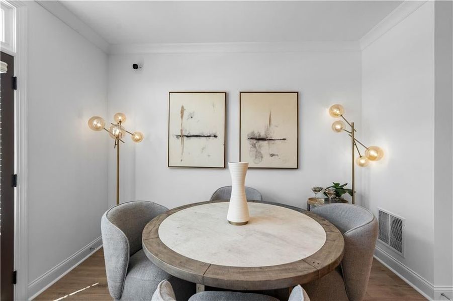 Bright Dining area in your open concept main level *Images shown are from a decorated model of the same floor plan. Design selections and color packages will vary by home.*