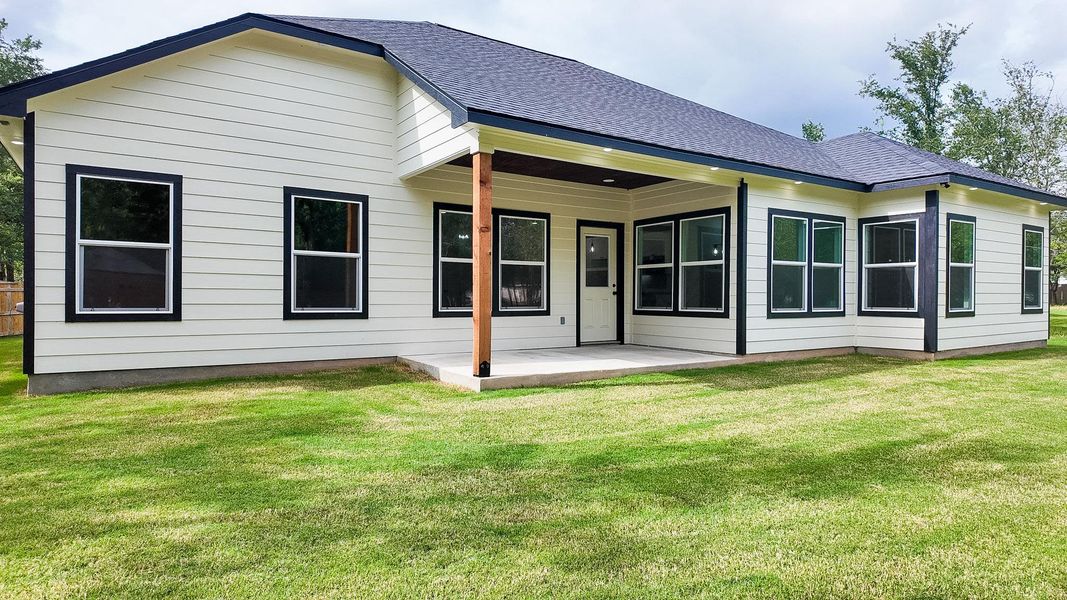 A newly constructed residence showcasing modern design elements and a functional outdoor living space.