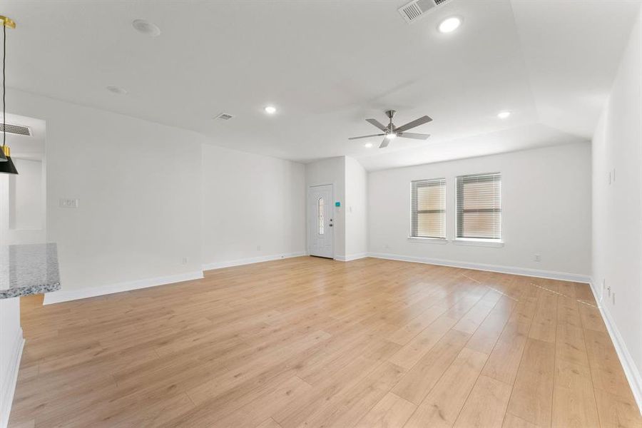 Living room with ceiling fan and light wood-type flooring