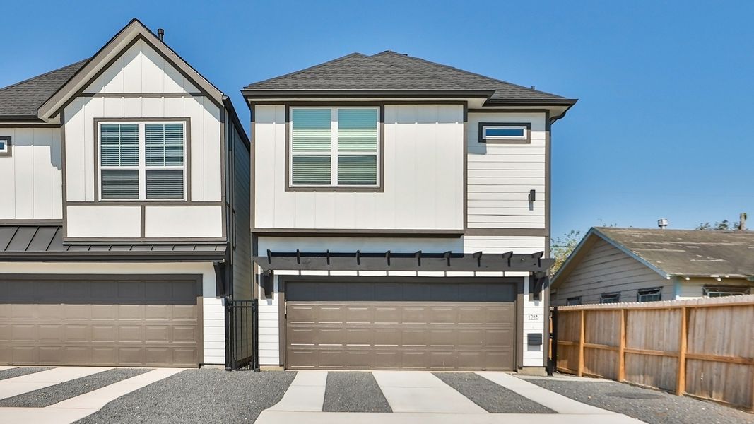 Sleek townhouses in Independence Heights feature minimalist design, gabled roofs, and elegant garage structures.