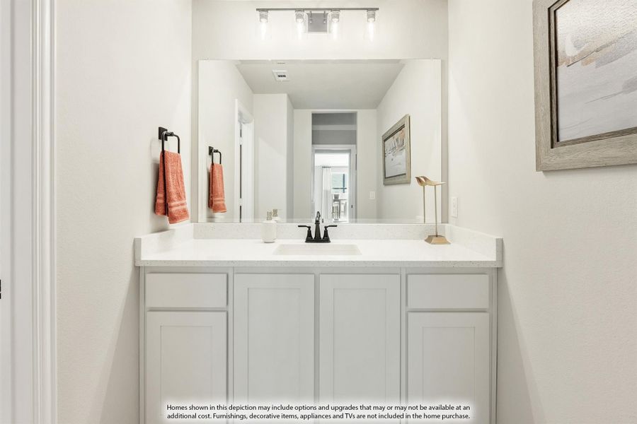 Bathroom vanity with white cabinets, quartz countertop, black faucet, and large mirror with overhead lighting Bathroom vanity with white cabinets, quartz countertop, black faucet, and large mirror with overhead lighting