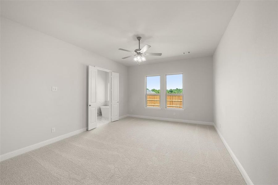 Empty room with a ceiling fan and light carpet Empty room with a ceiling fan and light carpet