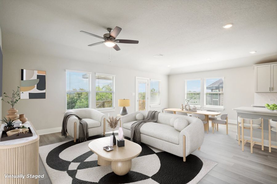 Virtually staged living room in in the Preston floorplan at a Meritage Homes community.