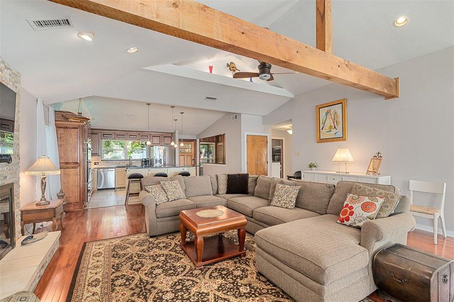 Vaulted ceilings with exposed wood beams define this living space
