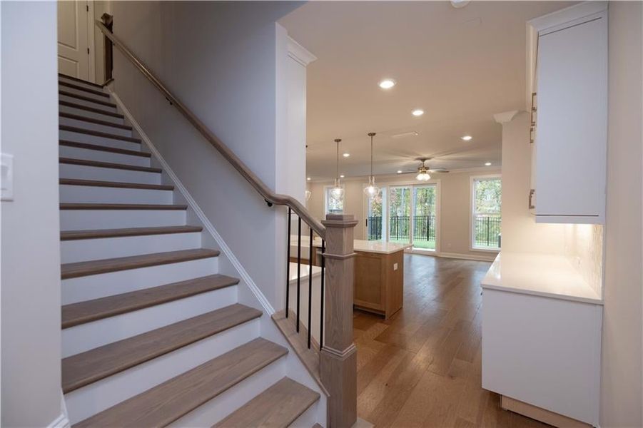 Staircase with recessed lighting, hardwood / wood-style flooring, and a ceiling fan