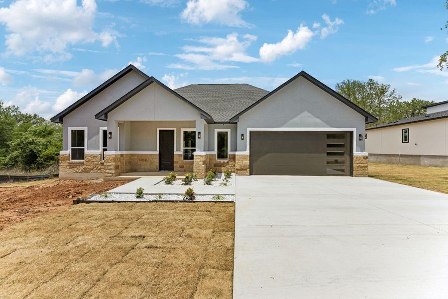 Front exterior of a new home in , Bastrop, TX, highlighting curb appeal (Image 20).